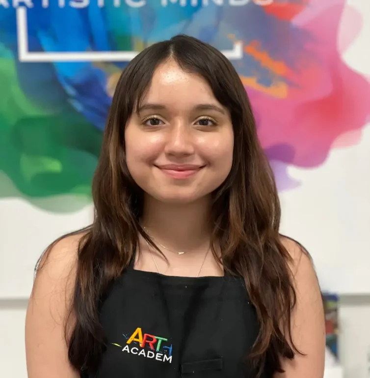 Professional portrait of art teacher with Art Plus Academy logo in the background at Southwest Austin location