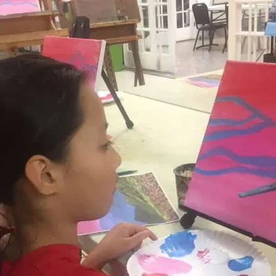 Two girls painting the same subject side by side during Art Class in Avery Ranch, each focused on their own work